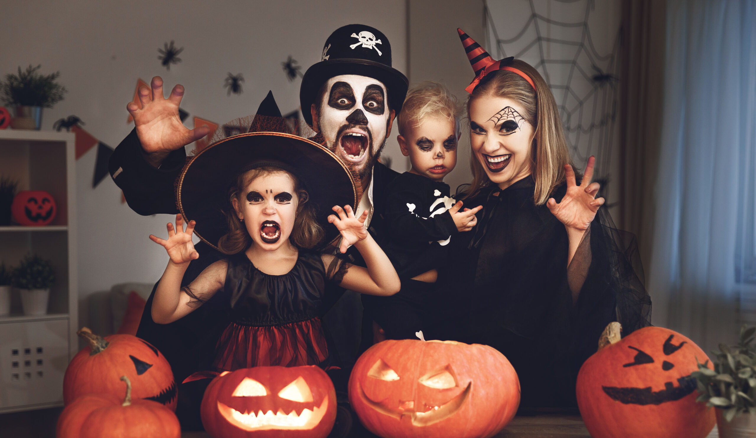 happy family mother father and children in costumes and makeup on  Halloween