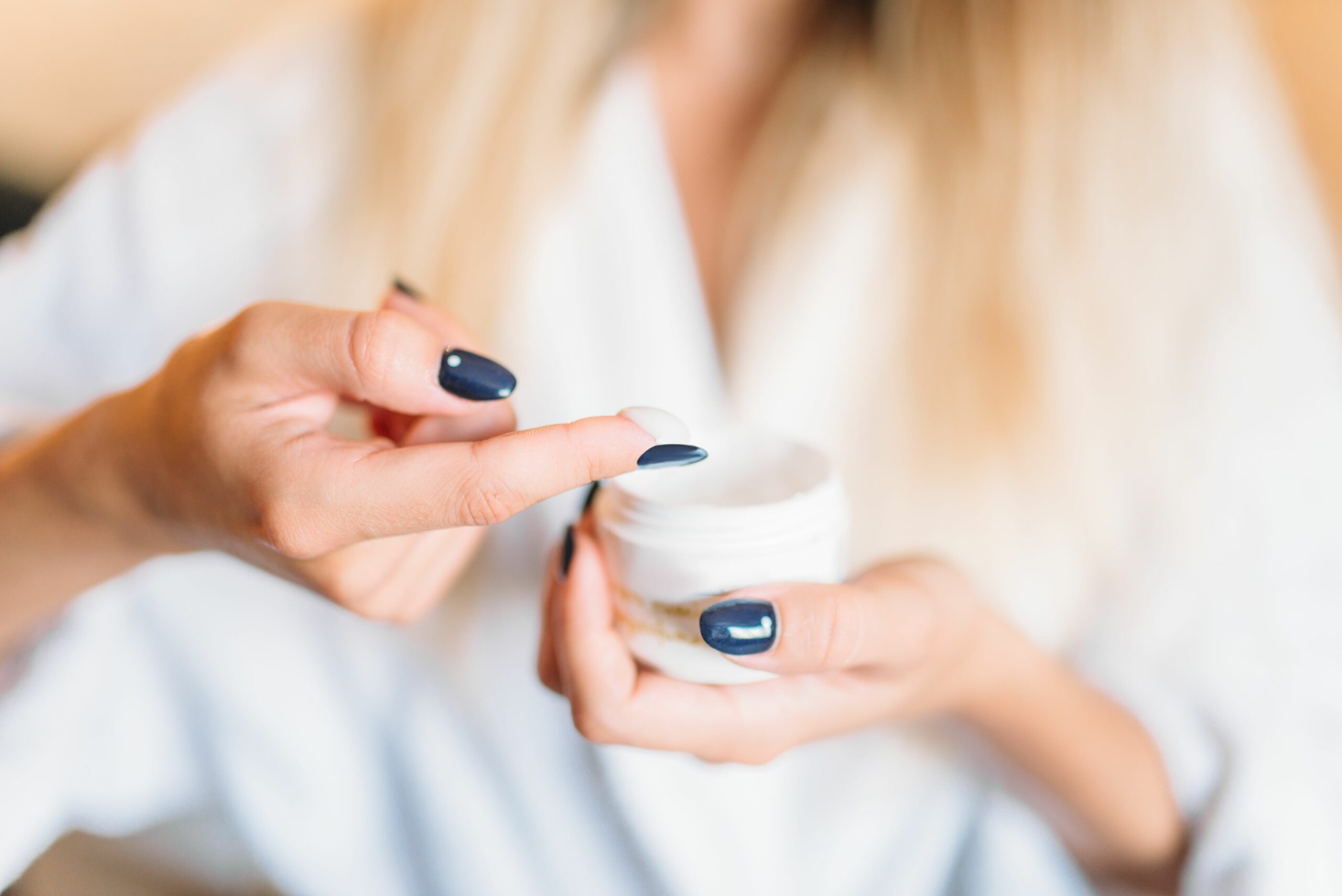 Smiling female person in bathrobe, skincare